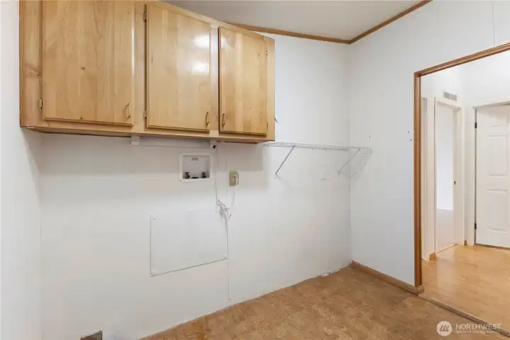 Large utility room offers washer/dryer hookups + additional storage space - has exterior door to carpet