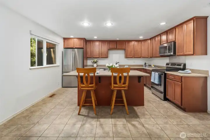 Kitchen with an eat-in island. View from the multi-purpose living room or dining room.