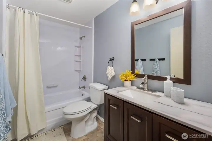 Hallway full bathroom with a tub.