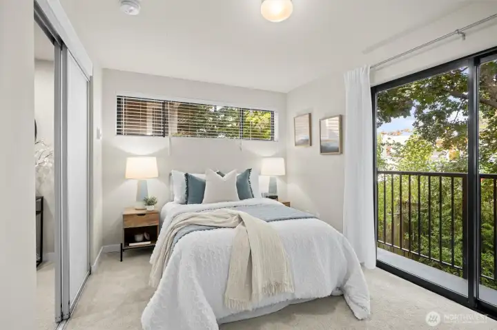 The second bedroom is on the same level as the Primary and has a slider/balcony that overlooks the shady backyard.