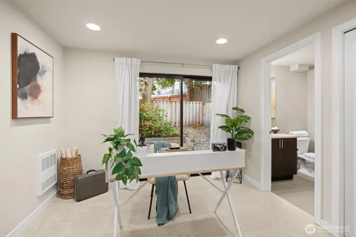 The first floor is where you'll find this first of our three bedrooms which is currently staged as a nifty home office. You'll notice there is a sliding door that opens to the beautiful backyard which features a large patio that's just perfect for entertaining.