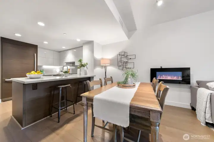 Dining area with electric fireplace.