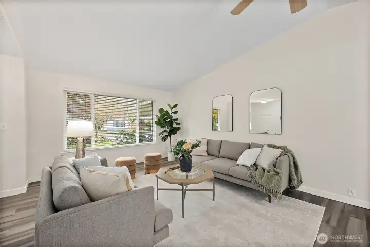 Living room is situated off the entryway with huge window bringing in lots of natural light. Watch the trees in the front change with the seasons.
