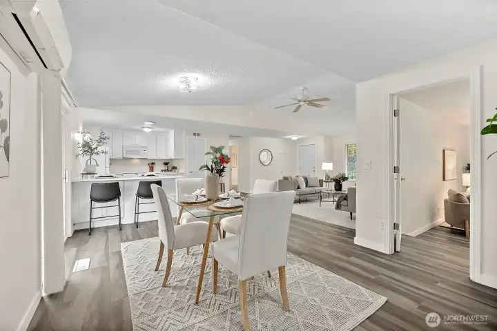 Dining room with primary suite to the right, looking out toward kitchen and living room/entryway.