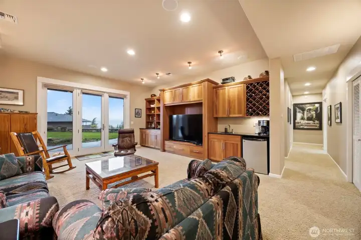The family room has a wet bar with a beverage refrigerator, as well as built-in cabinetry and storage. The bedrooms and full bath are down that hall.