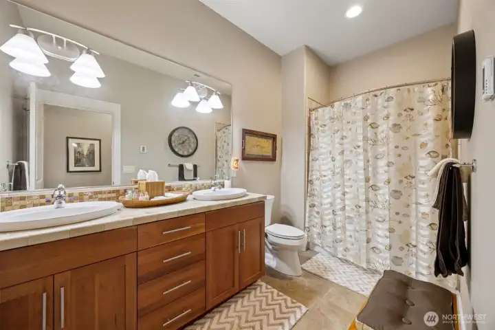 The full bath on the lower level also has the travertine tile and a large dual sink vanity. This is the only room that does not have a bay view!