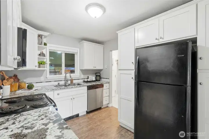 Stainless steel appliances complement the clean, modern design and make meal preparation a pleasure.