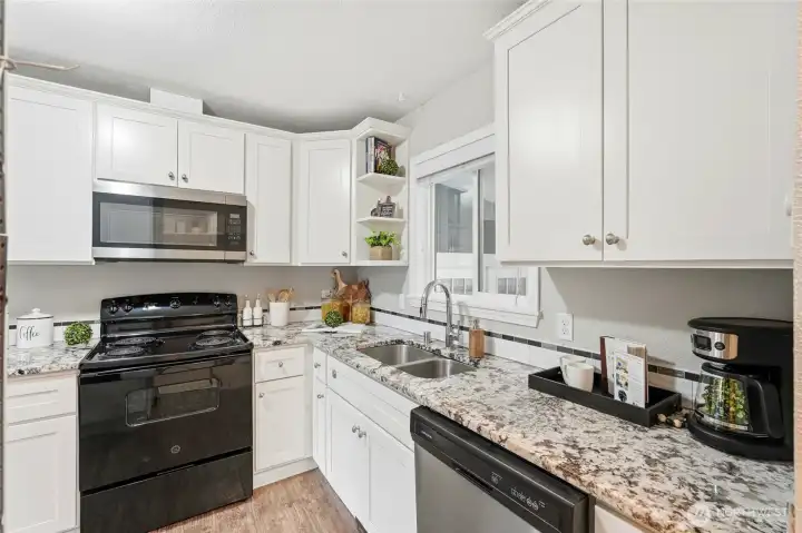 Granite countertops provide generous workspace while adding timeless durability and elegance.