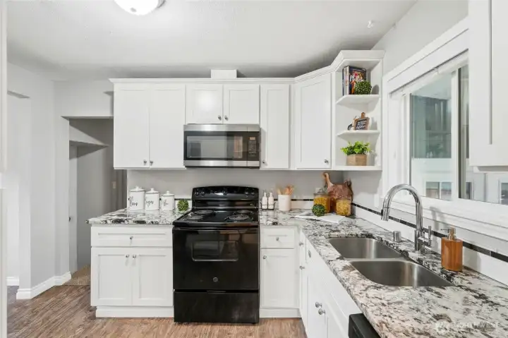 The open layout keeps the kitchen connected to the surrounding living and dining areas, creating a natural gathering space for family and guests.