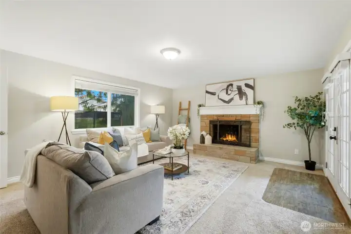 A cozy wood-burning fireplace creates a natural focal point while adding charm and character to the space.