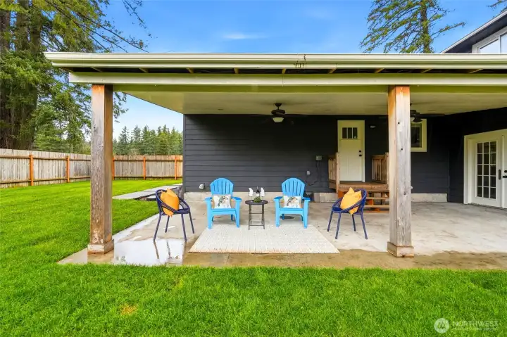 Huge covered patio with ceiling fans overlooking the newly landscaped yard—perfect for summer evenings and weekend gatherings.