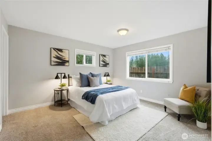 The main-level primary suite offers both comfort and convenience with a layout designed for easy living. Generous proportions provide plenty of space for larger furniture while maintaining a relaxing atmosphere. Located on the main floor, the suite offers privacy and accessibility without the need for stairs.