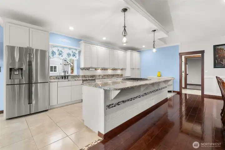 Spacious kitchen with large eat at island (granite countertops)