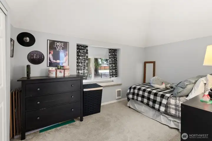 One of the secondary bedrooms boasts vaulted ceilings and a reading nook next to the window!