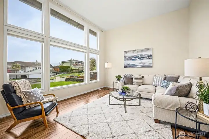 Floor to ceiling windows provide a beautiful view in the formal living room.