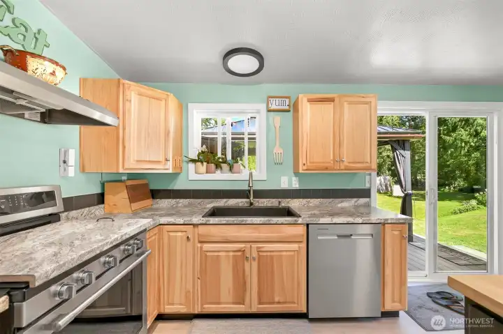 Bright kitchen with garden views, updated finishes, and functional workspace.