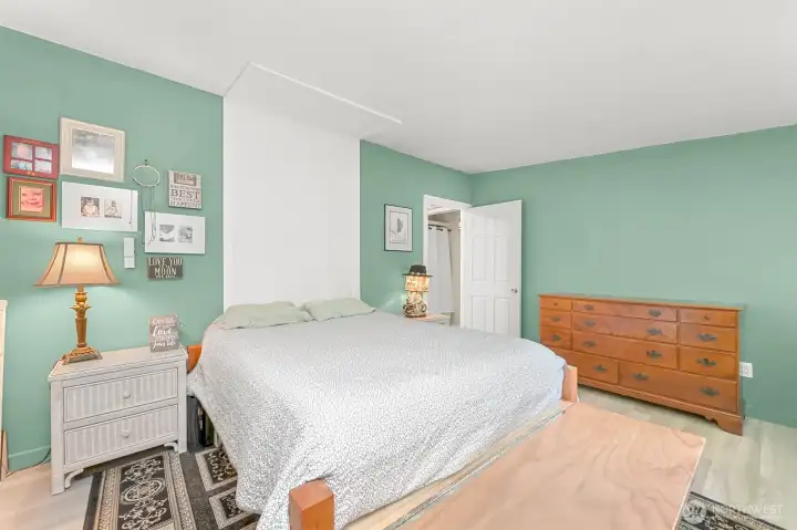 Comfortable primary bedroom with ample space for furnishings and convenient access to adjacent bath.”