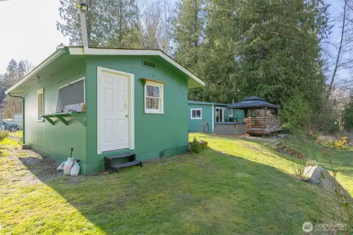 A detached outbuilding offers flexible use as a shop, studio, or additional space