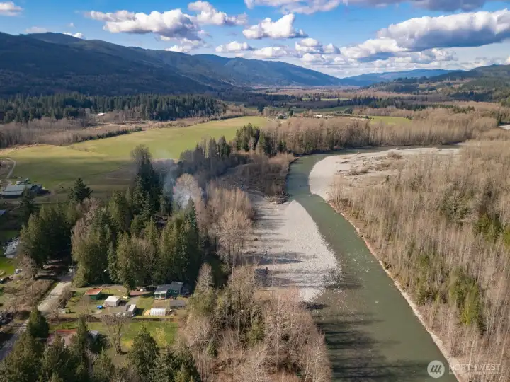 Wide, open river views with a mix of forest and mountain backdrop
