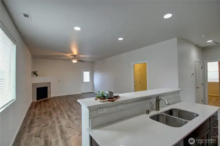 Dining & living room, with gas fireplace, high ceilings, door on right is to laundry & garage.  Back door accesses fenced backyard.