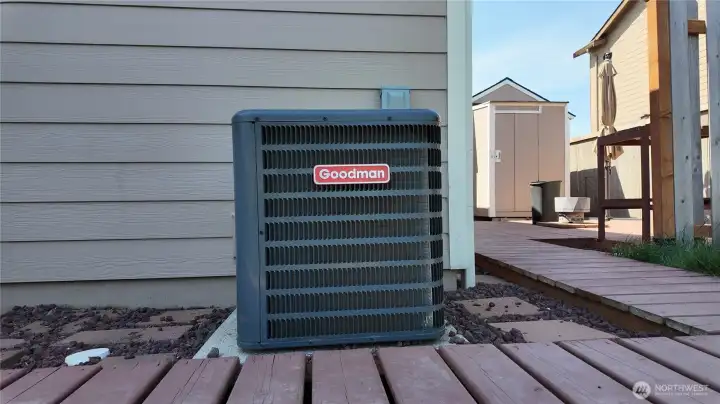 Heat pump just off walkway.