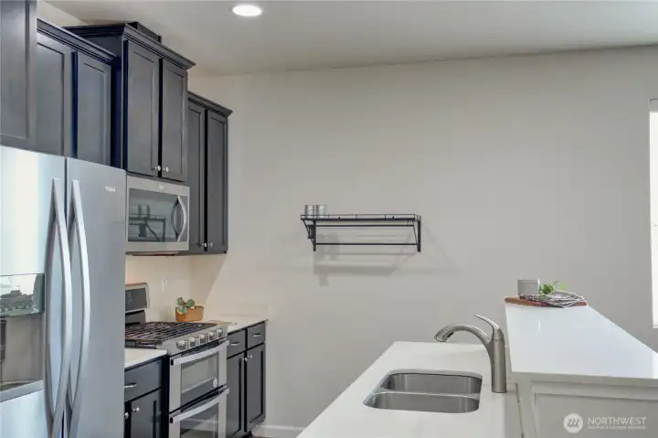 Quartz counters, double stainless sink and double oven.