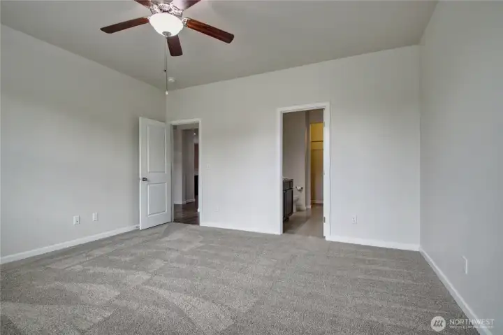 Primary bedroom looking towards hall and master bathroom & walk-in closet.
