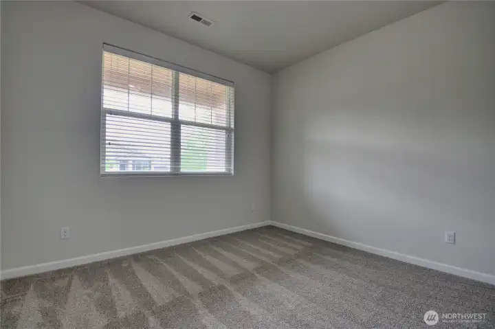 2nd bedroom is spacious and faces the front of the home.