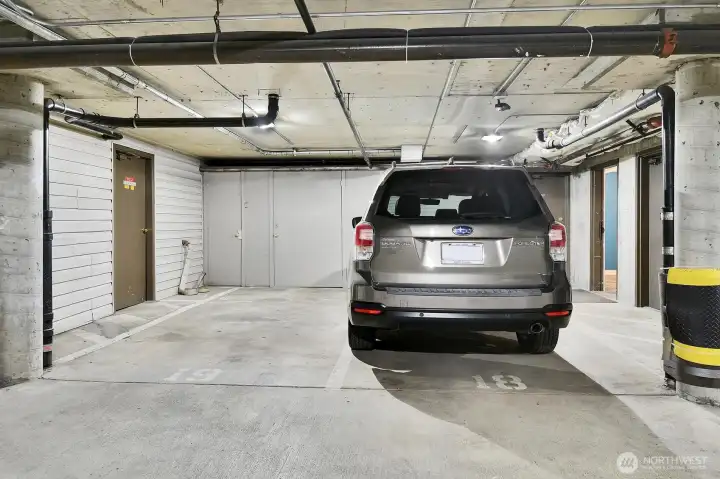These 2 parking spots come with the unit. The storage lockers in front of each are also included.