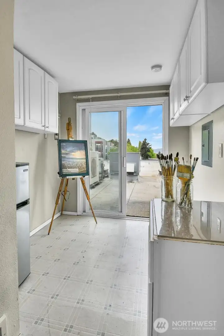One floor up from the unit sits this bonus space. It has it's own 3/4 bath out of frame to the right. Perfect office, art space, you decide...  Great views of Downtown skyline from the patio doors as well.