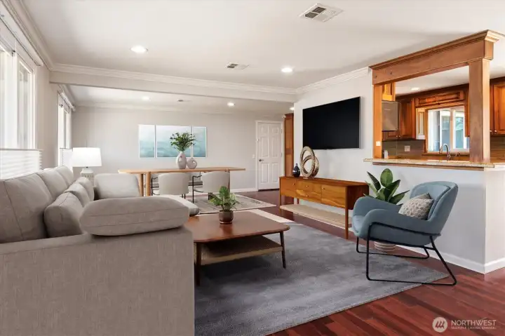 View of living and dining room from front door perspective (virtually staged).