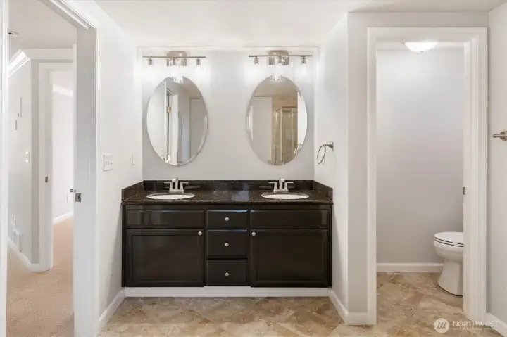 Dual vanity with separate water closet.