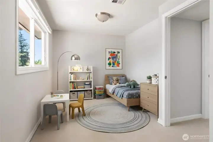 Guest bedroom #3, currently virtually staged as a kid’s room/play area.
