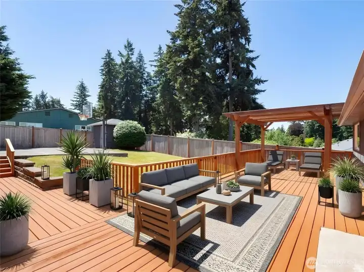 Gigantic deck right off the kitchen through the sliding glass door with additional access from the den (virtually staged).
