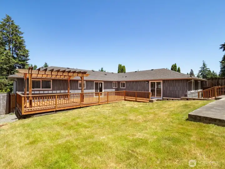 View of deck and back of home from the backyard.