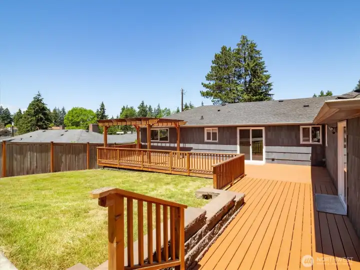 Additional view of the deck, backyard, and rear elevation of the home.