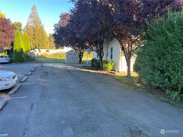 LOOKING DOWN DRIVEWAY OF HOUSE ON SMALLER LOT.
