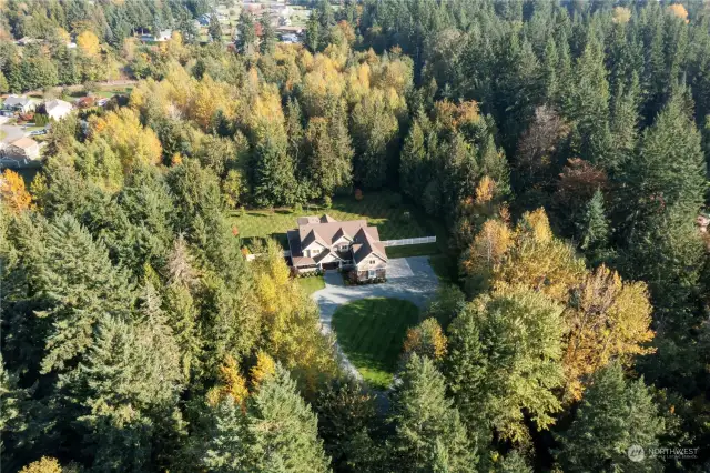 This wonderful estate is surrounded by gorgeous evergreens making a peaceful setting.