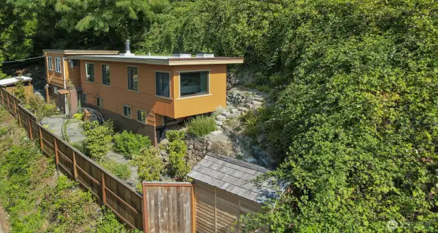 Drone view of Main (south) home and terraced side yard and garden shed.