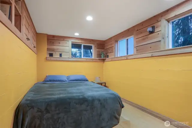 Main (South) home lower level bedroom with laminate bamboo floors and alternating tread staircase to upper level.   Has a separate entry, great income opportunity via vacation rental, housemate, etc.