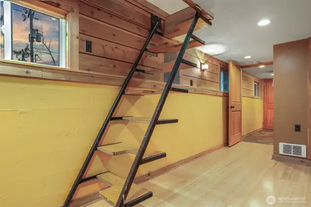 Main (South) home lower level bedroom with laminate bamboo floors and alternating tread staircase to upper level.   Has a separate entry, great income opportunity via vacation rental, housemate, etc.