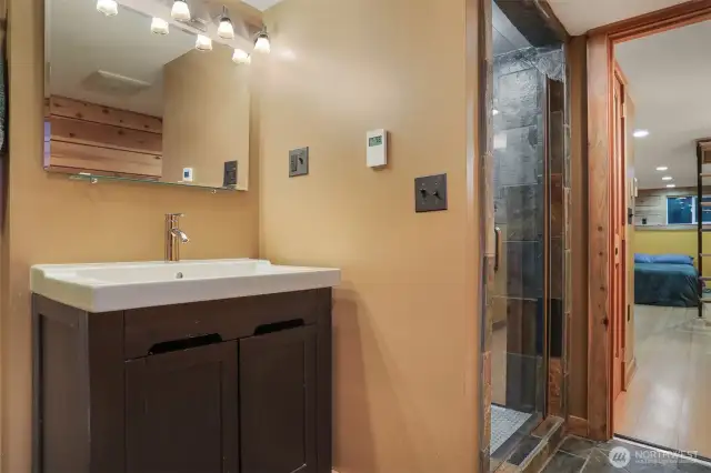 Main (South) home lower level remodeled tiled 3/4 bathroom with heated floors.   Has a separate entry, great income opportunity via vacation rental, housemate, etc.