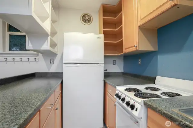 Cottage (North) home upper level kitchen opens to living room.