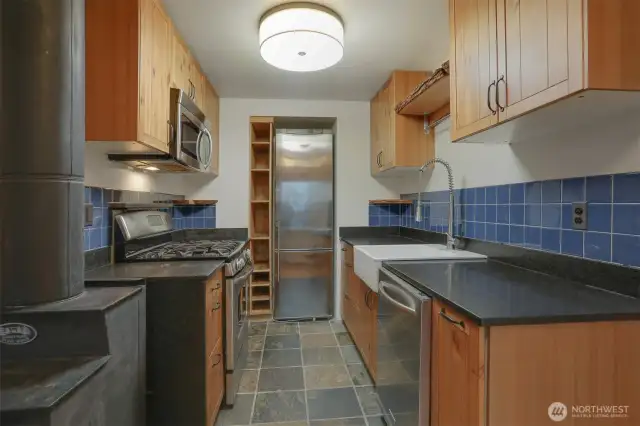 Main (South) home upper level Remodeled kitchen with tile floors, gas range, stainless appliances and bump out for the refrigerator.