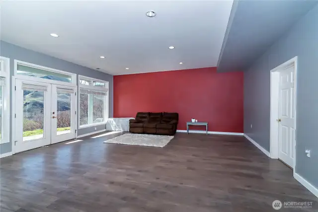 Downstairs living room with french doors out to lower patio and hot tub.