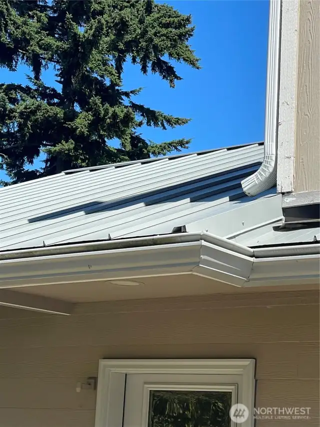 Recent metal roof with Leaf Guard type gutters