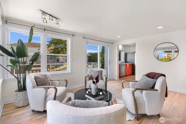 Sliding doors lead to wrap around deck with city views.