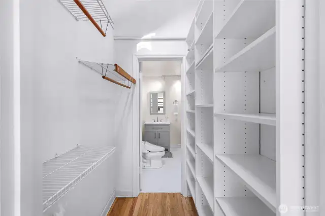 Walk-in closet which leads to primary bathroom