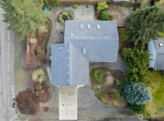 Birds eye view of roof and serene landscaping