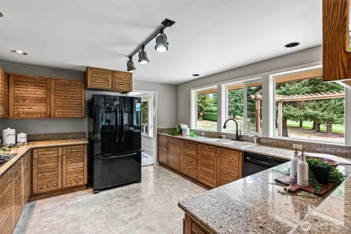 Kitchen with windows overlooking the stunning landscape and golf course.